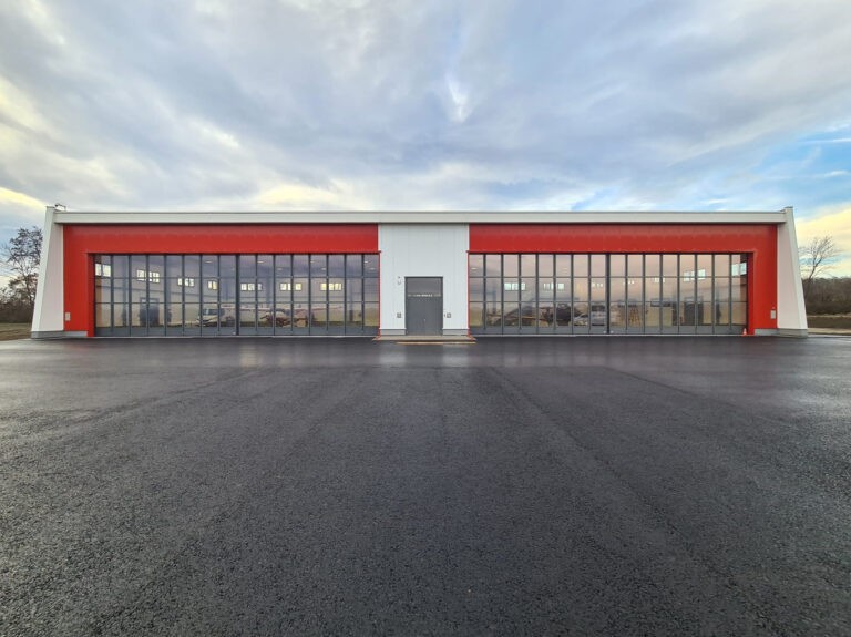 Two customised folding sliding doors for aircraft hangar